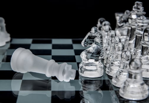 glass chess. defeated king on a chessboard. photo