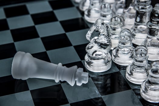 glass chess. defeated king on a chessboard. photo