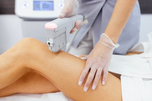 Relaxed young female client getting SMAS ultrasound body lifting massage photo