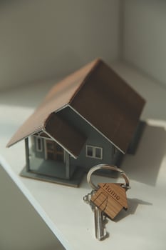 Real estate agent home sales broker is using a pen pointing to the house model and explains the business contract, rent, buy, mortgage, loan, or home insurance photo