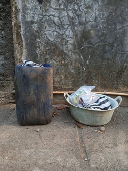 a bucket and a trash can sitting on the ground photo