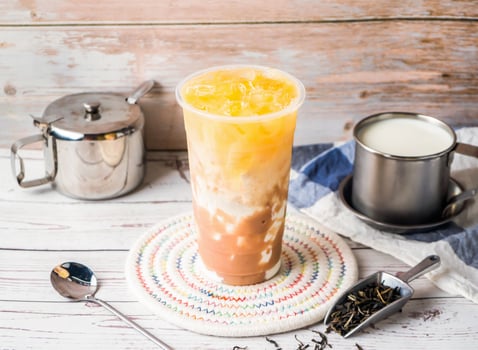 iced Taro Green Tea with Fresh Milk with sugar pot and spoon served in disposable glass isolated on table side view of hong kong tea photo