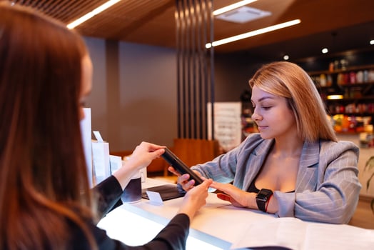 Smiling female client communicates with reception woman in a beauty salon photo