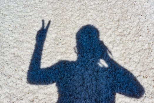 The shadow of a man on the white surface of the self-sedimentary salt of the drying Kuyalnitsky Estuary, Ukraine photo