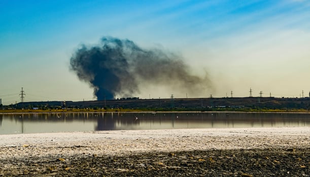 Fire smoke against the backdrop of the Kuyalnitsky estuary in the evening before sunset photo