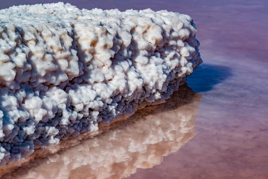 Salt Lake. Self-settling sodium chloride salt on rocks near the shore. Hypersaline water photo
