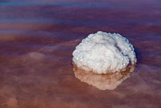 Salt Lake. Self-settling sodium chloride salt on rocks near the shore. Hypersaline water photo