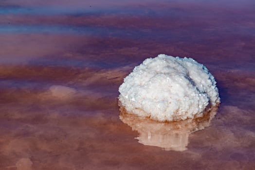 Salt Lake. Self-settling sodium chloride salt on rocks near the shore. Hypersaline water photo