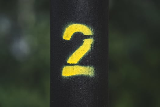 Yellow number two on the street lamp. Yellow number two, on a black background photo