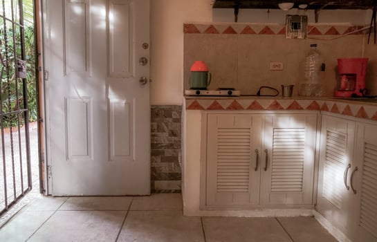 Playa del Carmen Quintana Roo Mexico 2023 Simple apartment hotel room with bed table kitchen in Mexico. photo