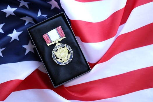 KYIV, UKRAINE - JULY 10, 2024 Distinguished Service medal. United States military award medal with ribbon and pin. Handmade paper theater props photo