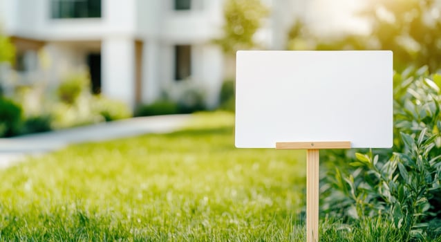 A blank wooden signpost in a green garden setting, perfect for customization or signage in outdoor spaces. photo
