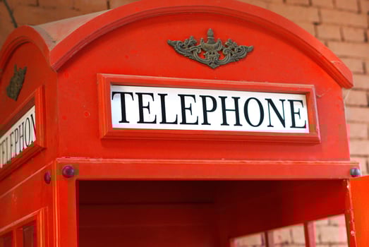 text on red telephone booth public payphone box photo