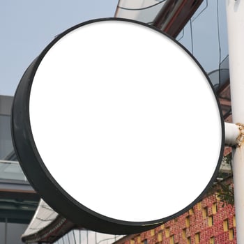 Round mock up sign on white building wall, amazing for your business logo photo