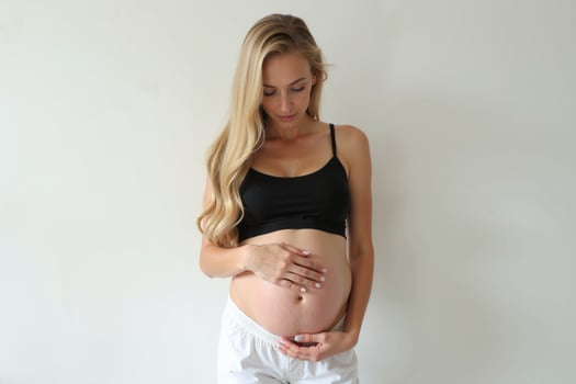 photo of pregnant woman standing pose on white background,
