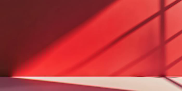 A vibrant, striking red wall casting intricate shadows, showcasing the fascinating interplay of light and color photo