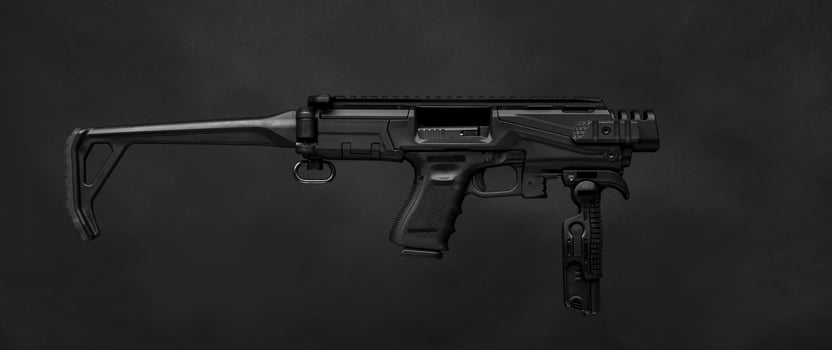 modern black submachine gun on a black photo