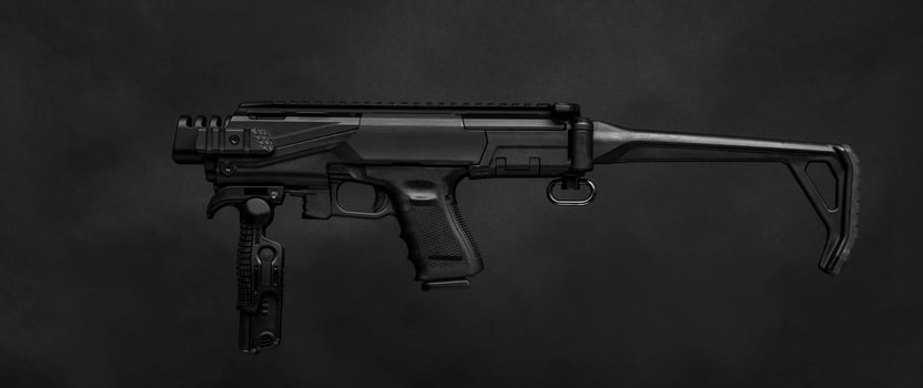 modern black submachine gun on a black photo