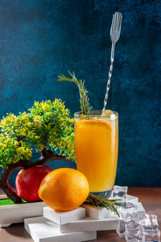 Refreshing Orange Juice with Decorative Elements and Natural Scenery photo