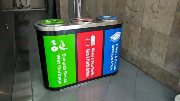 a trash can with three categories of trash. wet, plastic and paper waste photo
