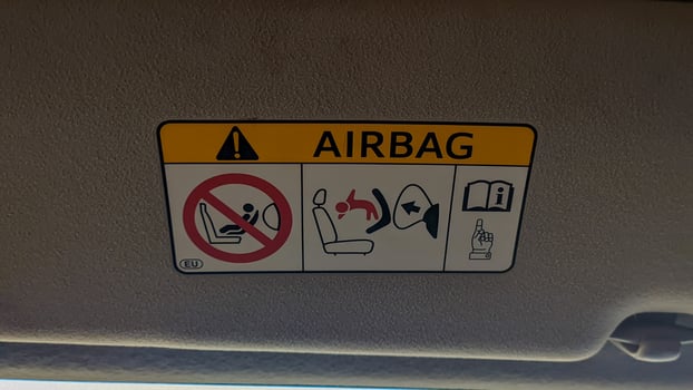 Airbag warning sign, built to reduce the impact of bumps in vehicles, helps to reduce serious injuries to adults or children. Surabaya, indonesia - may, 2023 photo
