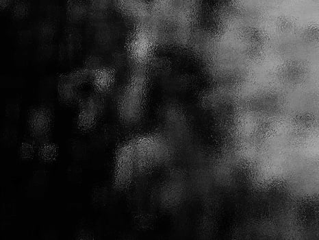 A black and white photo of a person in the rain