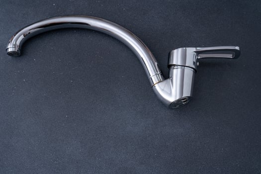 Chrome-plated mixer tap for water in the bathroom and kitchen. Plumbing. photo