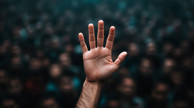 Closeup of a persons hand reaching out desperately through a thick crowd the crowd blurred to highlight the sense of urgency photo