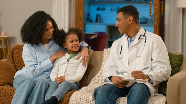 Happy African American mother daughter doctor woman man girl smiling medicine child pediatrician visit parenting health medicare patient kid therapist childcare wellbeing happiness home family enjoy photo