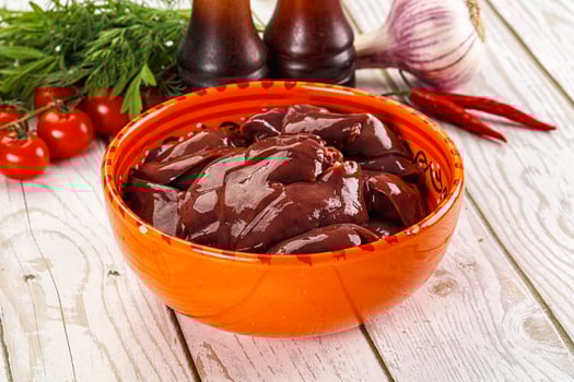 Raw chicken liver uncooked in the bowl photo