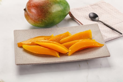 Canned mango slices in the bowl photo