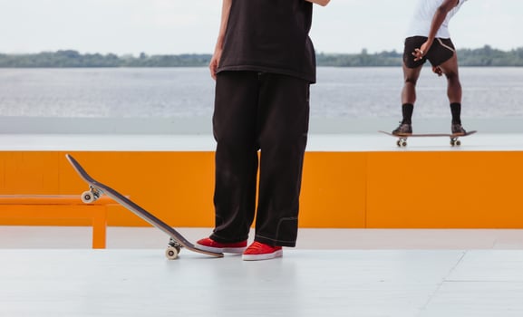 Man's legs with skateboard in skatepark photo