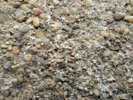 Texture of small sea pebbles. Natural stone seamless background. Rough surface of pebble stone. Design for wallpaper, print, and interior. Top view, soft daylight photo