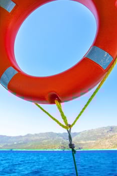 Orange lifebuoy on a back of blue sky. photo