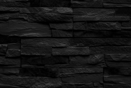 Black stone wall of a building. Interior of a modern loft. Abstract background design. photo