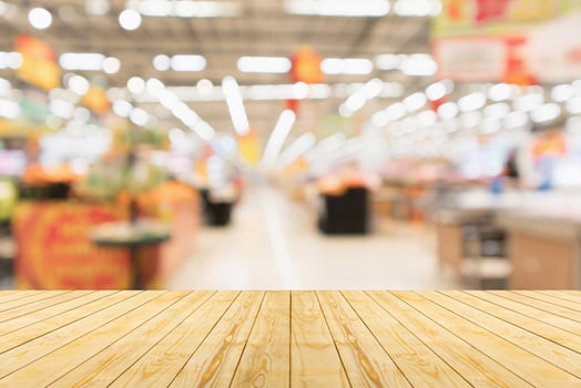 Empty wood table top with supermarket blurred background for product display photo