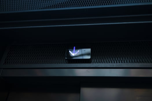 Digital elevator display showing arrow down, lift going down and up at mall, hotel or business center. Close up view. Technology and transportation concept photo