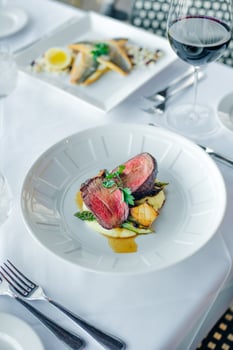 Closeup of a steak with vegetables in a restaurant setting photo