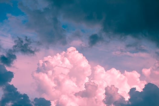 Magic pink fabulous cumulus clouds on blue sky at sunrise sunset nature background wallpaper photo