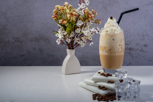 A fresh creamy iced coffee frappe topped with whipped cream photo
