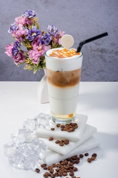 Elegant Latte with Coffee Beans and Vintage Clock on Wooden Table photo