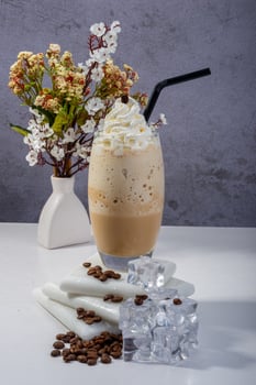 Icy Coffee Frappe with Whipped Cream and Floral Decor photo