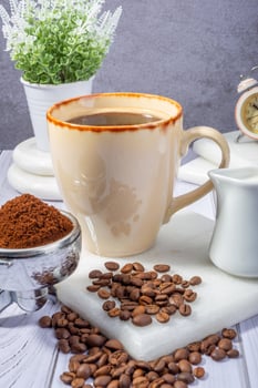 Elegant Latte with Coffee Beans and Vintage Clock on Wooden Table photo