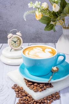 coffee beans, ground coffee, and a steaming mug of freshly brewed coffee photo