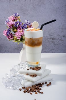 Fresh glass of Iced Coffee Frappe with Whipped Cream and Floral Decor photo