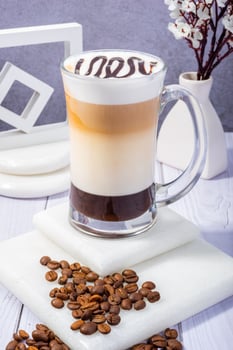 Elegant Latte with Coffee Beans and Vintage Clock on Wooden Table photo