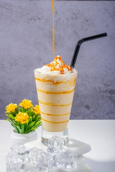 Fresh Coffee Frappe with Whipped Cream and Floral Decor photo