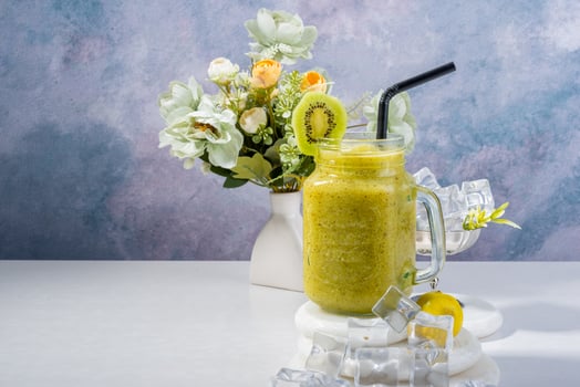 healthy Kiwi Smoothie with Ice and Floral Arrangement photo