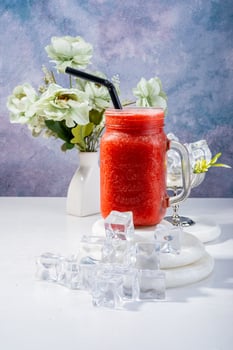 Strawberry Juice Smoothie with Ice and Floral Decor photo