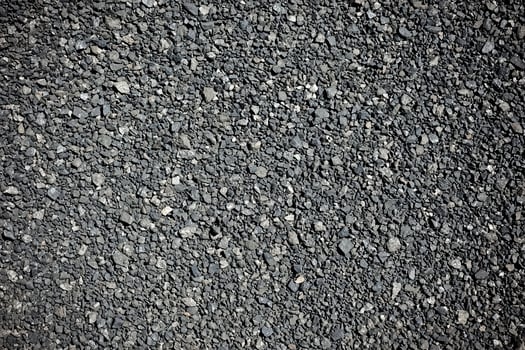 A rugged and dark asphalt texture background with a slightly rough surface photo